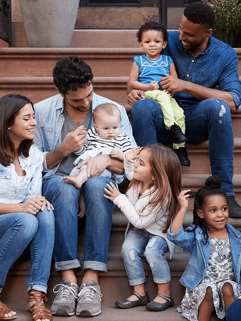 Families sitting on a townhouse stoop
